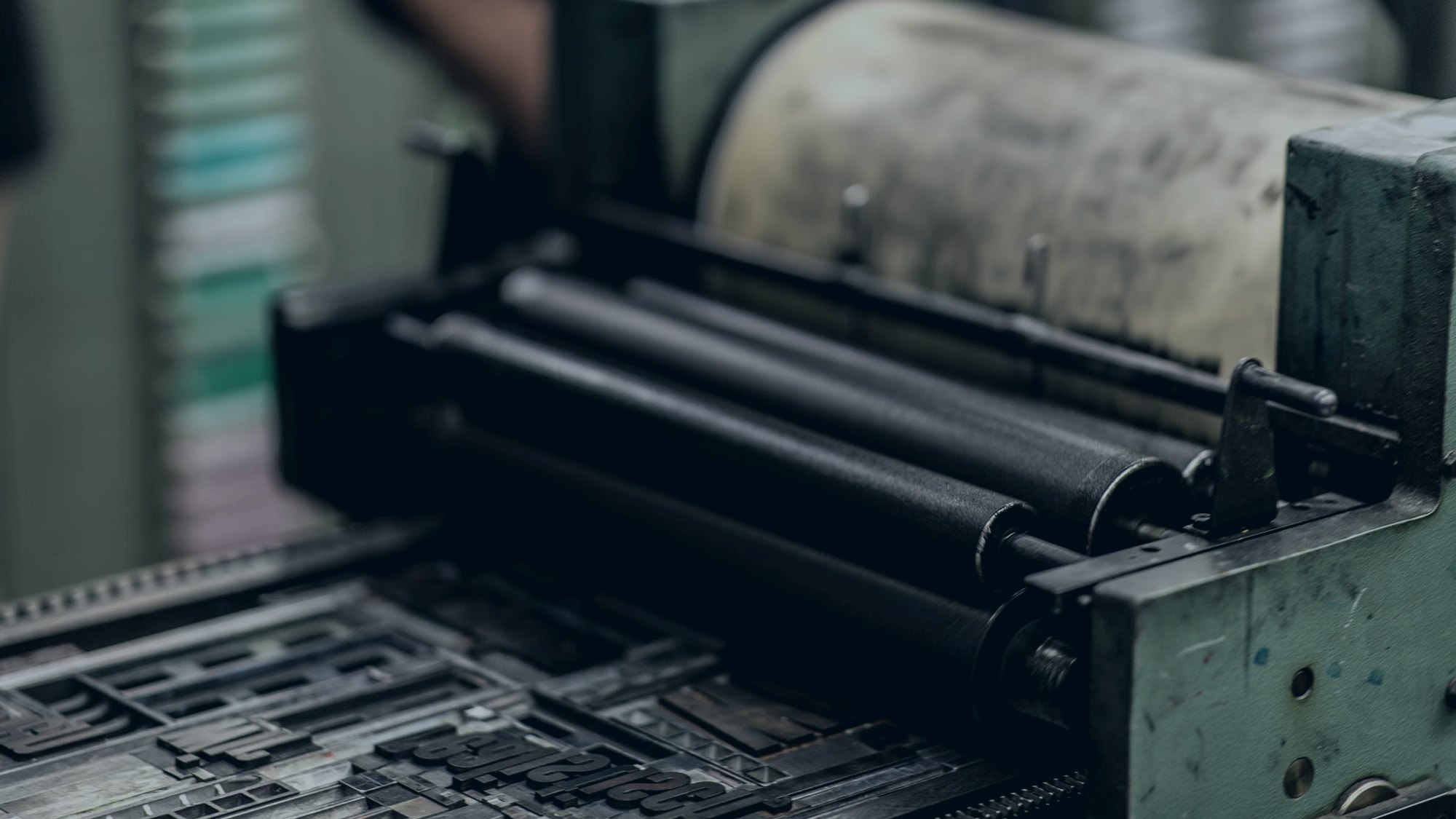 Press operator checking colour registration on a printed packaging web